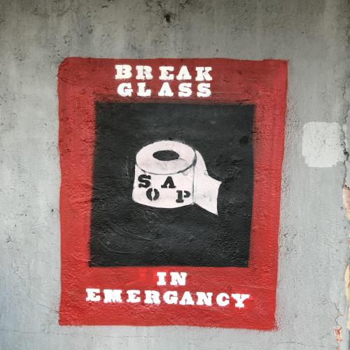 Grafitti shows an image of loo roll with a &#039;break glass&#039; message above