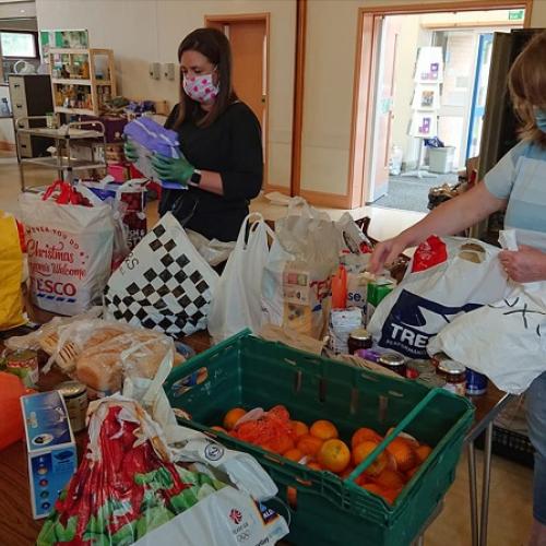 Volunteers work at the food bank sorting food