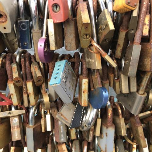 Colourful padlocks span a bridge
