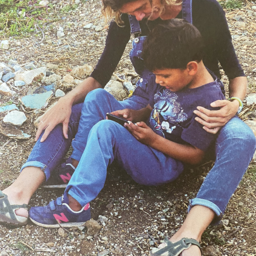 a women sits together with a boy