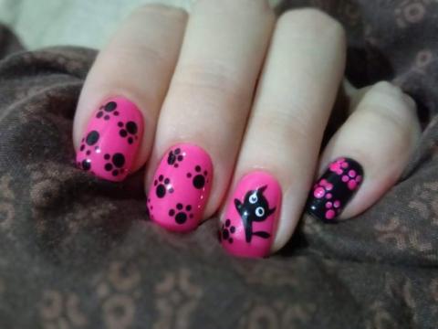 women'd hand with pink nail polish