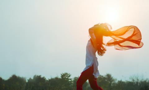 women throwing scarf in the sunset