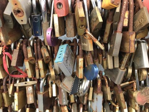 Colourful padlocks span a bridge