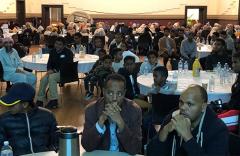 People sitting around tables in a conference room