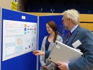 Hillary explaining the poster to Professor Nick Braithwaite. 