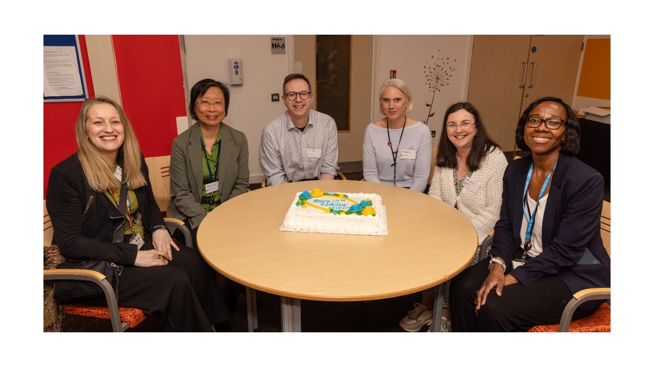 The management team and some of the former Directors sitting at a table