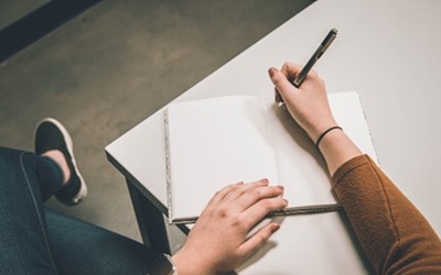 Person writing in notebook