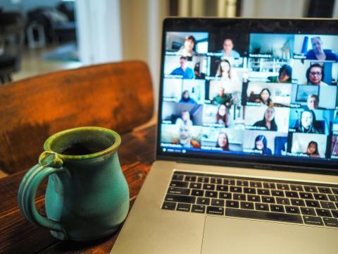 Online meeting with green mug on the foreground