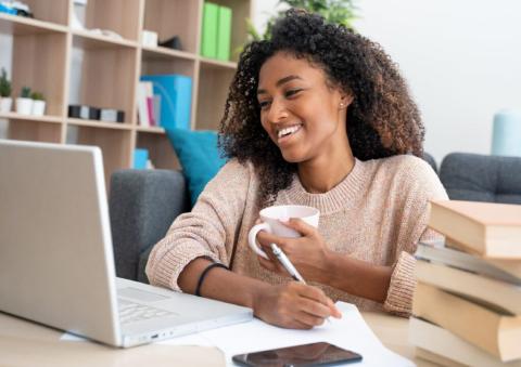 Student looking at computer and smiling