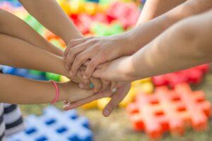 Image of hands on top of one another in a circle