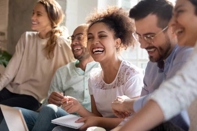 A group of young people talking and laughing together