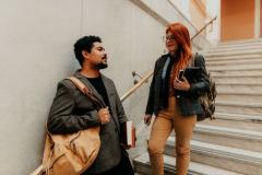 Two students talk on stairs