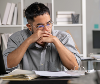 man deep in thought trying to study 