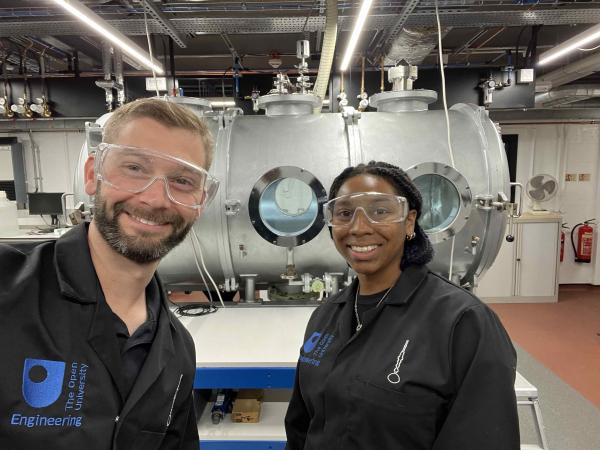Prof. Jacob Adler and Sharissa Thompson posing in front of George Chamber during their experiments