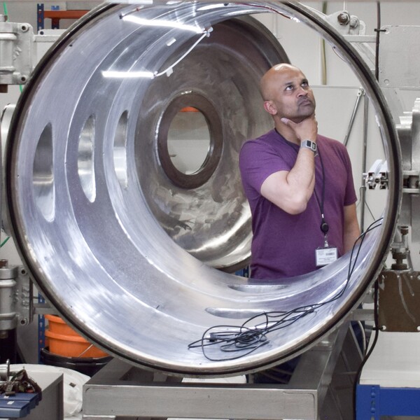 Prof. Manish Patel standing on one side of the chamber deep in thought looking at the insider of the chamber
