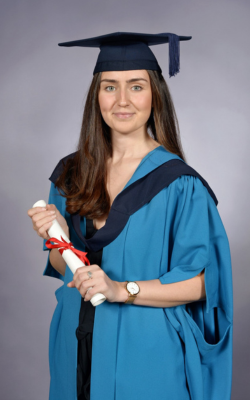 Jade Taylor pictured in a gown and wearing a mortar board, at the ceremony for her OU Postgraduate Diploma in Social Work.