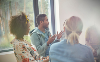 Group of people sitting on chairs placed in a circle