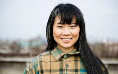 A woman outdoors smiling directly at the camera