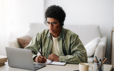 Young person typing on a laptop at home. 