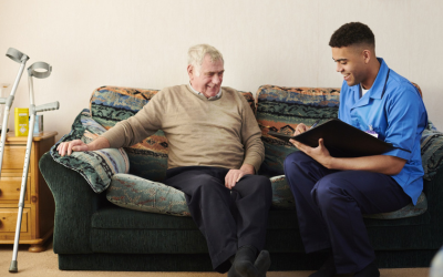 Care worker speaking with an elderly man