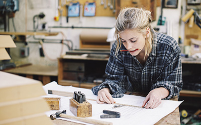 An engineering student doing calculations in a workshop