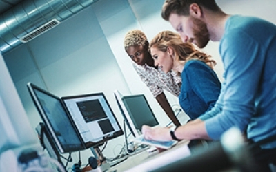 Three people working at computers