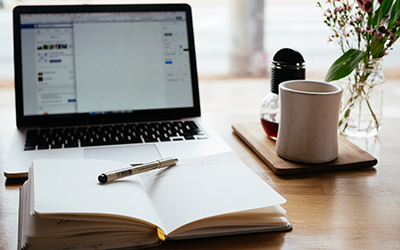 Laptop, notebook, pen, flowers