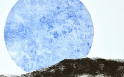 Print of a blue moon in front of a white background.