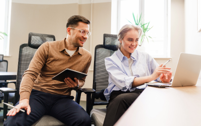 A man and a women working together on a laptop