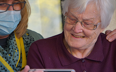 Two adults looking at an electronic device