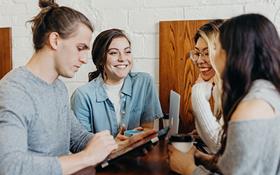 Four young people seated at a table