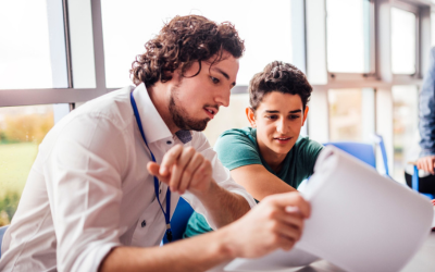 A teacher working with a pupil