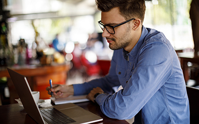 A man working on a laptop in a cafe