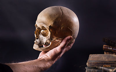 Man holding a skull