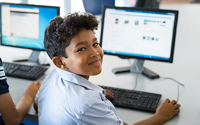 A primary school pupil using a computer