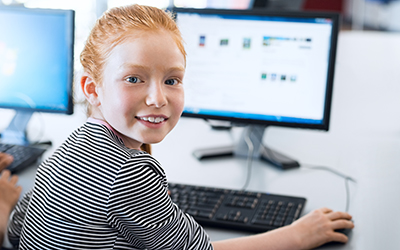 A primary school pupil using a computer