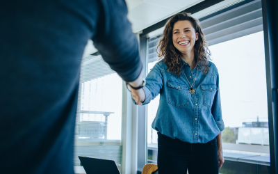 A woman shaking hands with someone after an interview