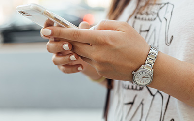 A close up shot of a woman's hands holding a mobile phone