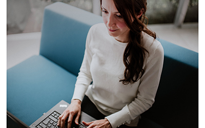 A seated lady using a laptop