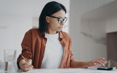 A woman uses a calculator to work our her finances