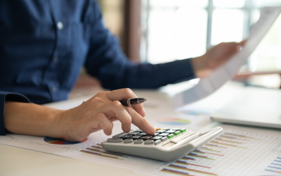 A person using a calculator at their desk