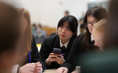 A high school student looking at her phone