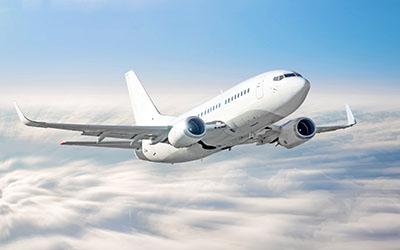 Image of an airplane gaining altitude above the clouds