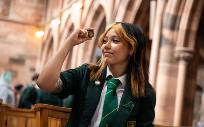 A pupil holding a piece of rock at the European Lunar Symposium's schools' programme.