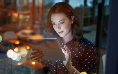 A woman looking at a tablet device