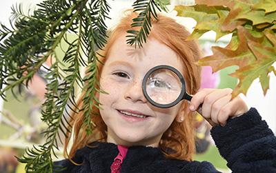 A child looking through a magnifying glass