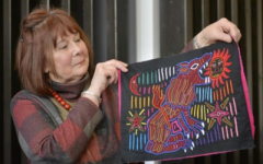 Clare Hunter holding up an embroidery.