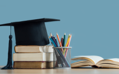 Photo of a mortarboard, books and colouring pencils