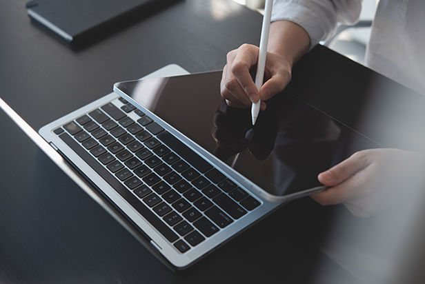 Gray apple wireless keyboard beside black tablet computer and stylus pen