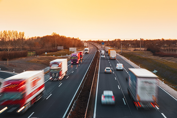 Busy highway with fast moving vehicles in beautiful sunset